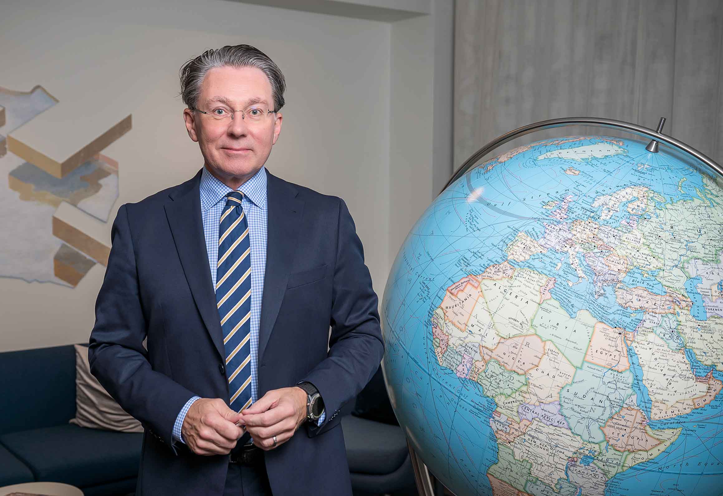 Carl-Johan Karlsson standing next to a giant globe