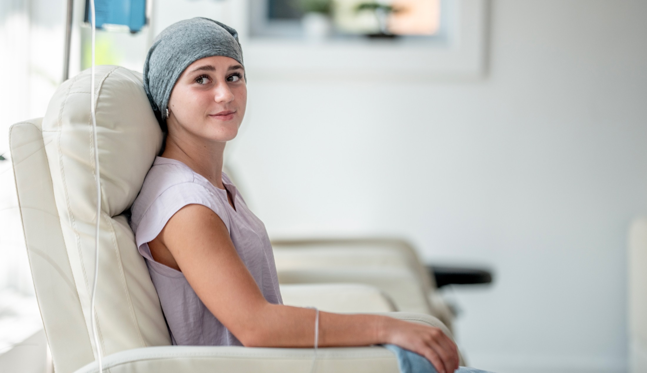 A young woman receiving cancer treatment