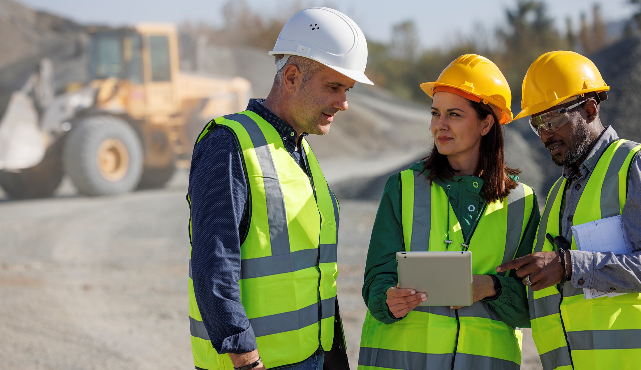 Team of engineers discussing at mining site