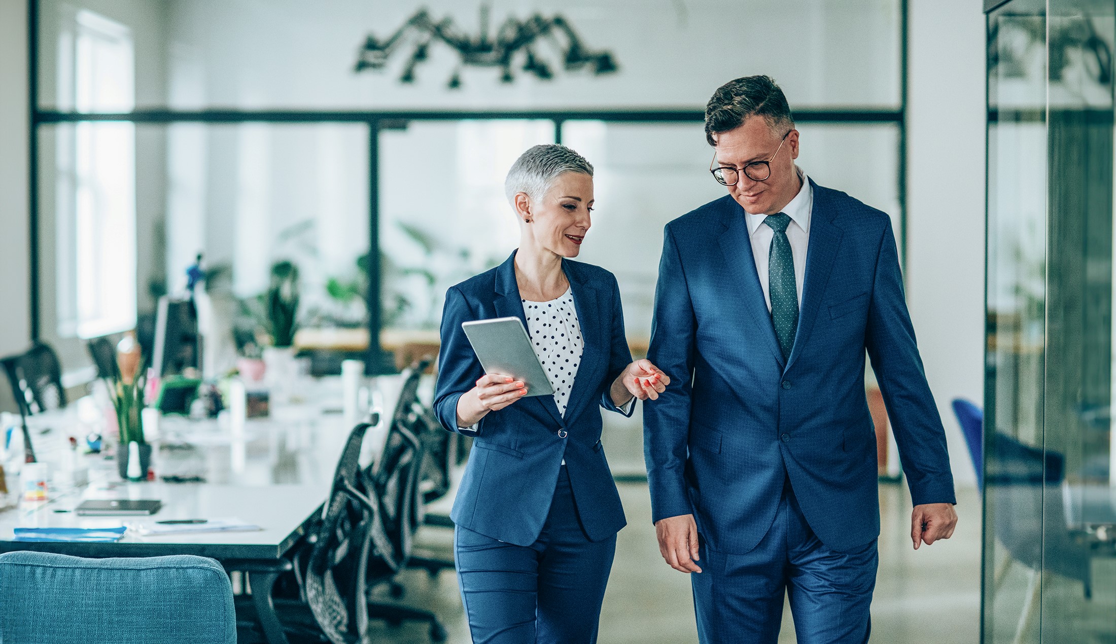 Woman and man talking in an office.