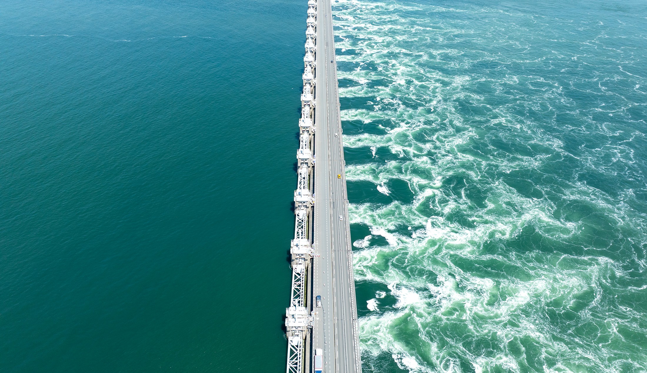 Aerial view of a flood barrier in the Netherlands, protecting coastal areas from rising sea levels and storm surges.