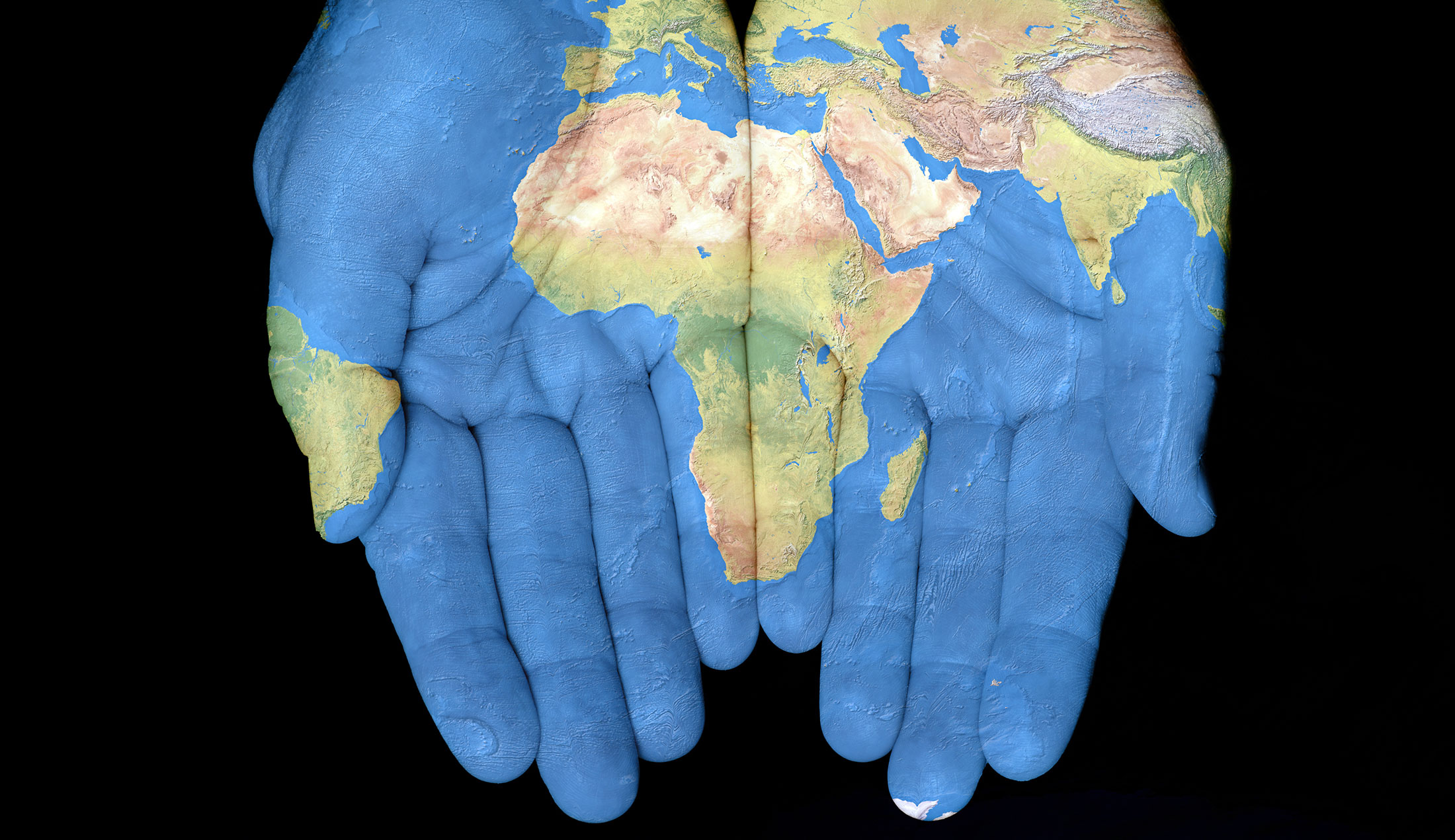 hands with a world map painted on them