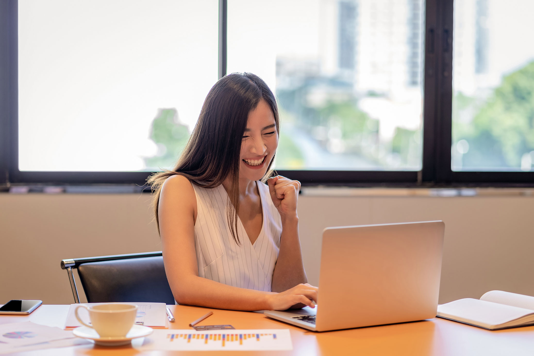 Happy woman by a computer