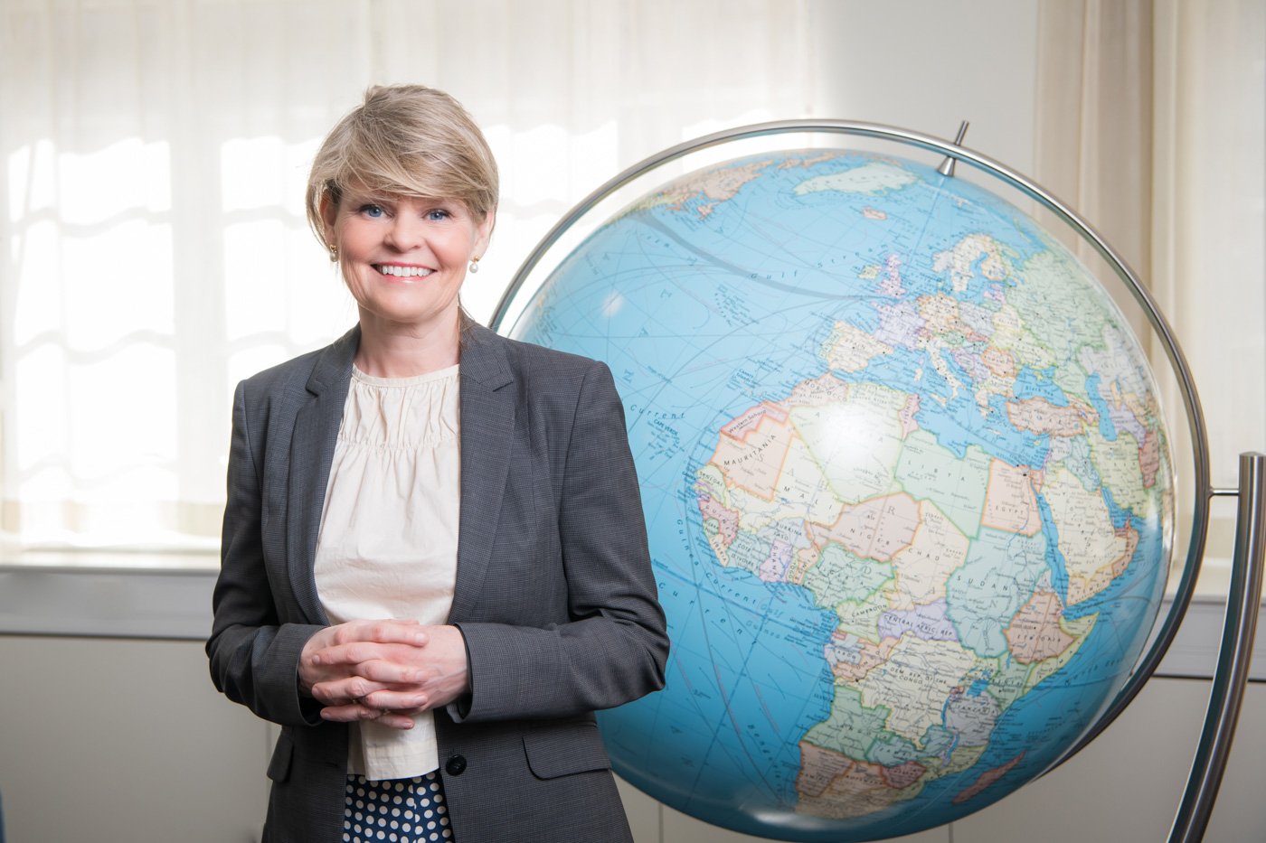 Lena Bertilsson framför en jordglob